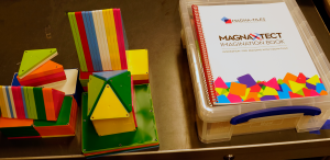 Kids playing with colorful magnetic tiles